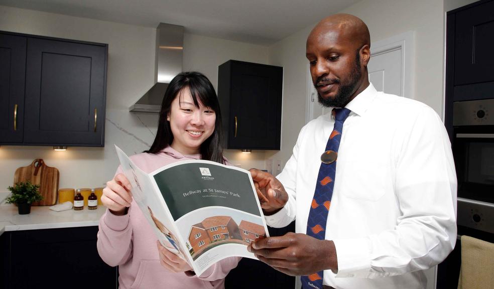 • Bellway customer Yeung Ka Man with Bellway Sales Advisor Cory Smith looking through the Bellway at St James’ Park brochure.